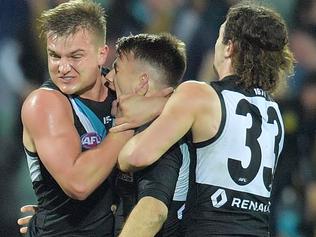 Robbie Gray of the Power (second right) celebrates with teammates after kicking the winning goal during the Round 19 AFL match between the Port Adelaide Power and the St Kilda Saints at Adelaide Oval in Adelaide, Saturday July 29, 2017. (AAP Image/David Mariuz) NO ARCHIVING, EDITORIAL USE ONLY