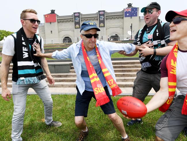 Port Adelaide fans Tim Tomblin and expat Anthony Blatti (right) with American expat Kevin O'Neil (second from left) and Barry Forrest before the game. Picture: AAP