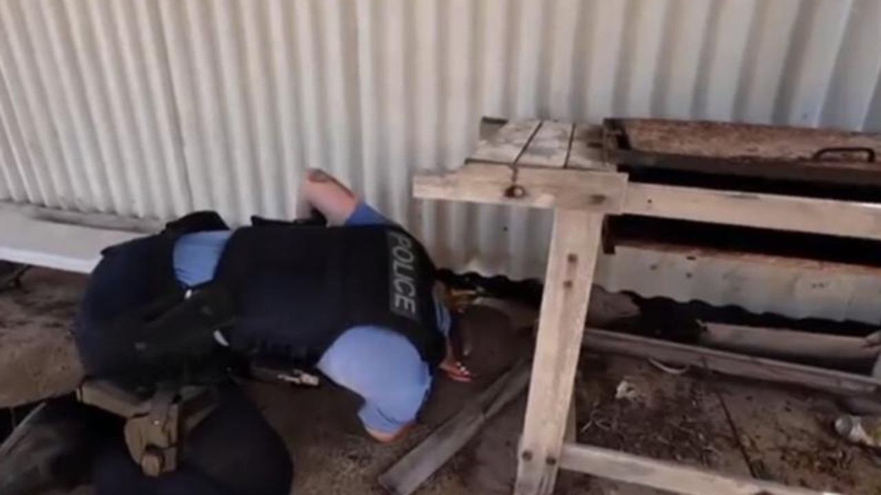 Police search under a metal hut in the Blowholes camping ground on the WA Shark Bay coast. Picture: Channel 7.