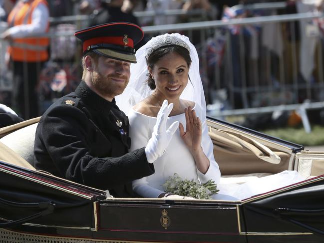 Prince Harry and Meghan Markle ride in an open-topped carriage after their wedding ceremony at St. George's Chapel in Windsor Castle. Picture: Aaron Chown/AP