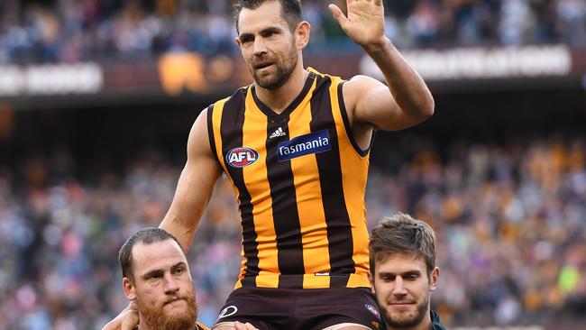 Grant Birchall (right) chairs former Hawthorn teammate Luke Hodge from the field.