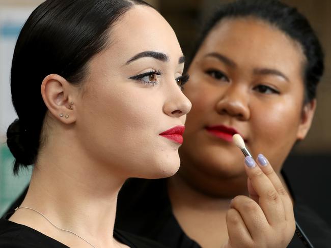 Alexandra Anderson and Gwen Catamura apply their skills at the Kangan Institute. Picture: Mark Dadswell