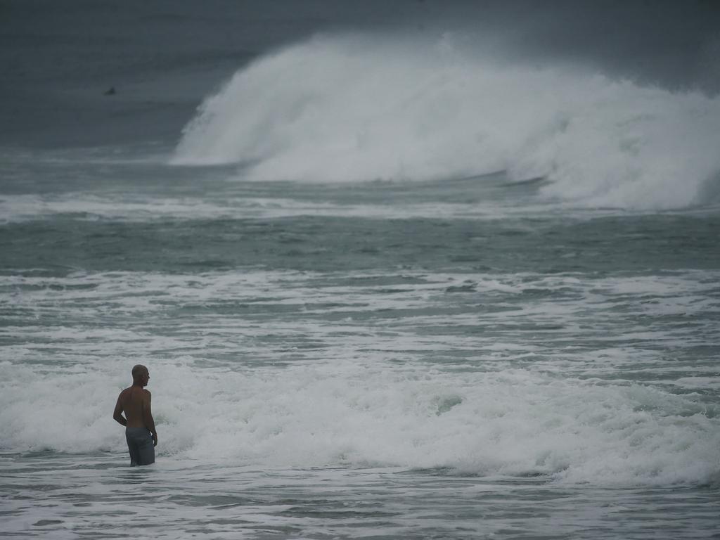 Tourists and Locals ignore Beach Closed signs as a large a swell hits Australia’s east coast. Picture: NewsWire / Glenn Campbell