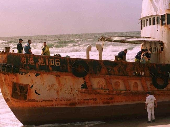 Customs officers on a Chinese junk ship that contained boat people stranded on Scotts Head Beach in 1999.