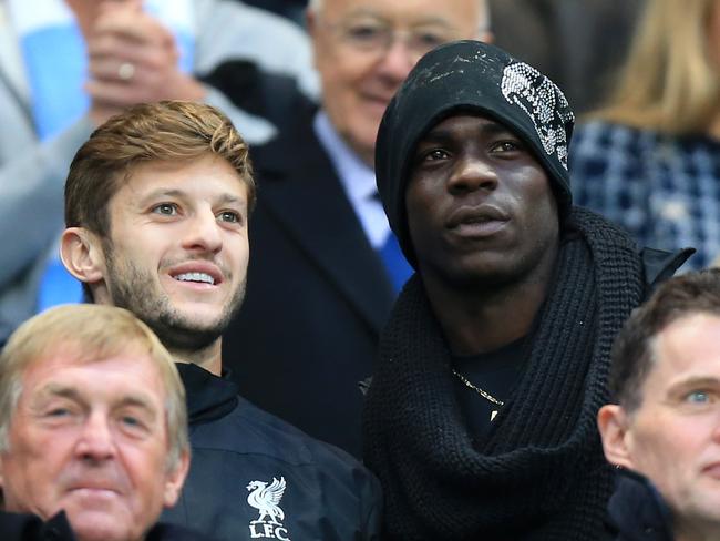 Liverpool's Adam Lallana, left, and Mario Balotelli in the stands during the English Premier League match at the Etihad Stadium, Manchester, where Manchester City were playing Liverpool, Monday Aug. 25, 2014. (AP Photo/PA, Peter Byrne) UNITED KINGDOM OUT NO SALES NO ARCHIVE