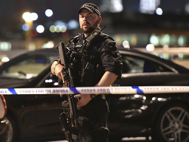 Armed Police officers stand guard on London Bridge. Picture: Dominic Lipinski/PA