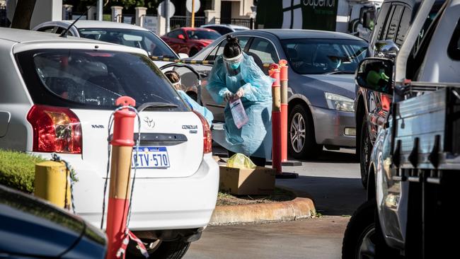 Medicos attend to people at the Orrong Road site of a drive-through test facility in Perth. NCA NewsWire/Tony McDonough