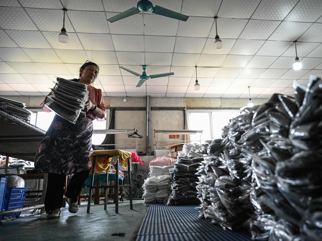An employee sorts out garments for the online Chinese e-commerce company Temu at a clothing factory in Guangzhou, in southern China. Picture: AFP