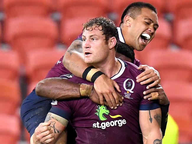 Duncan Paia'aua jumps on Reds teammate Scott Higginbotham after Higginbotham scored the winning try. Picture: Getty Images