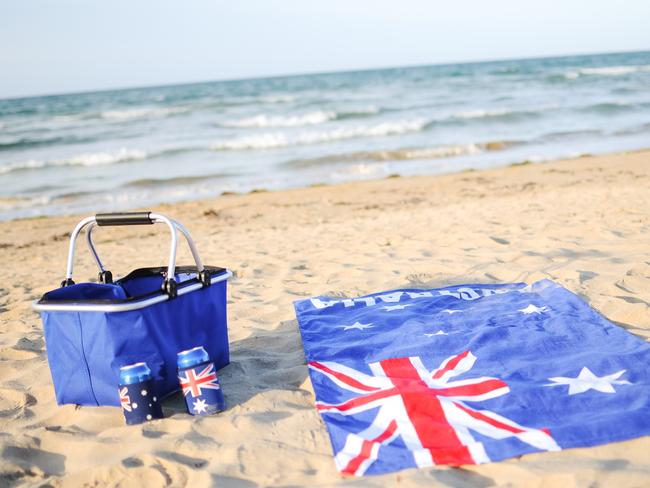 Cooler, drink and beach towel on the sand of a northern Tasmanian Beach in Australia.