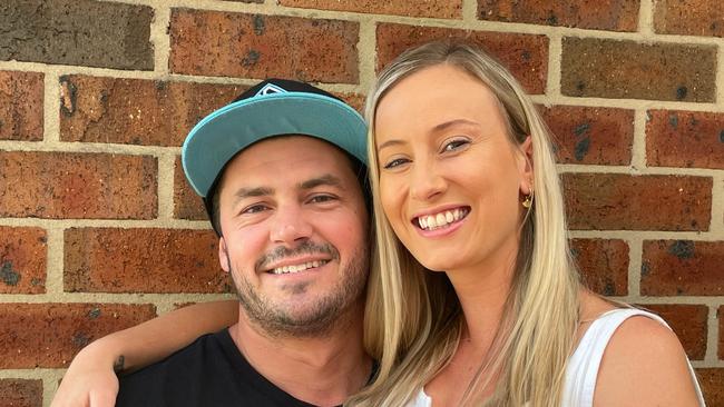 Newcastle bodyboarder Ryan Duck at home with his partner Sophie Ceccato. The 35-year-old has been released from hospital after allegedly being stabbed multiple times at Pacific Palms on November 27, 2022. Picture: Dan Proudman