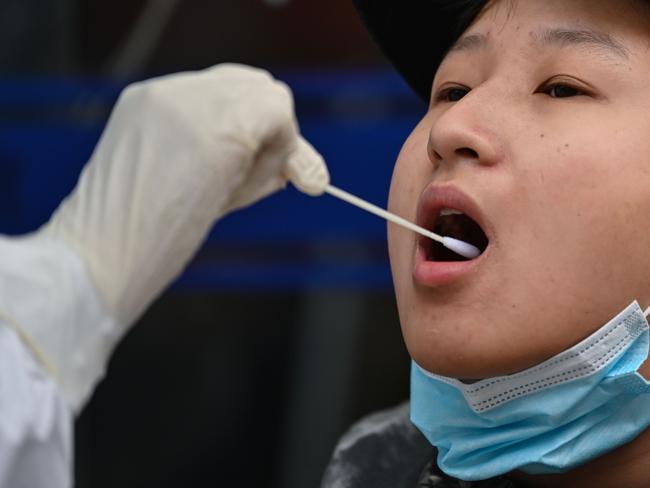 A medical worker takes a swab sample from a person to be tested for the COVID-19 novel coronavirus in Wuhan, China's central Hubei province. Picture: AFP