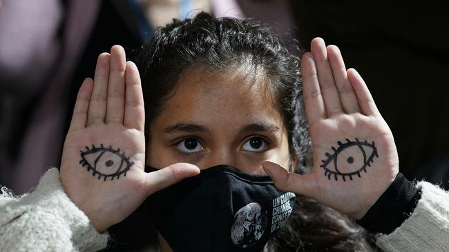 Youth climate activists protest as they build a human corridor. Picture: Getty Images