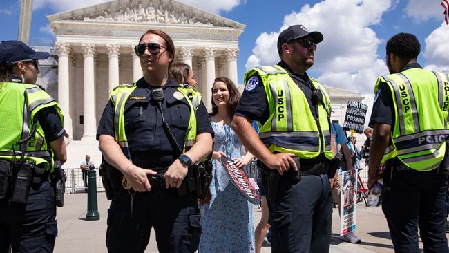 Anti-abortion activists stand behind a line of police officers in front of the US Supreme Court during a Women's March rally on June 24 to mark the one year anniversary of the overturning of Roe v Wade. Picture: Anna Rose Layden/Getty Images North America/Getty Images via AFP