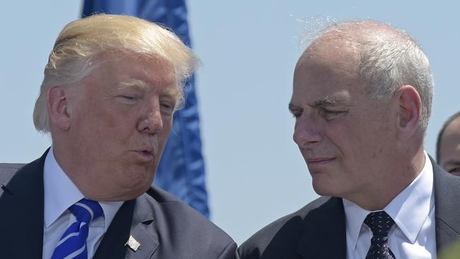 President Donald Trump talks with then Homeland Security Secretary John Kelly during commencement exercises at the U.S. Coast Guard Academy in New London, Conn. Trump named Kelly as his new Chief of Staff on July 28, ousting Reince Priebus. Picture: AP/Susan Walsh.