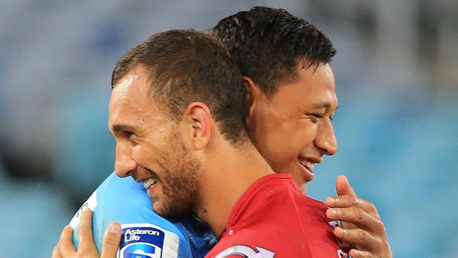 Israel Folau hugs Quade Cooper after the Waratahs v Queensland Reds Super Rugby game at ANZ Stadium, Sydney. pic mark evans