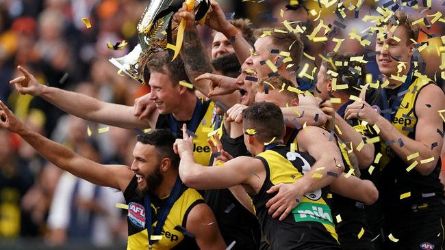 Richmond players react after receiving Australian Football League 2019 Premiership Cup after winning the  2019 AFL Grand Final between the Richmond Tigers and the GWS Giants at the MCG in Melbourne, Saturday, September 28, 2019. (AAP Image/Michael Dodge) NO ARCHIVING, EDITORIAL USE ONLY