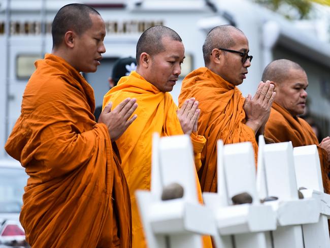 Buddhists pay their respects at a memorial outside the Tree of Life synagogue after a shooting there left 11 people dead in the Squirrel Hill neighborhood of Pittsburgh, Pennsylvania on October 29, 2018. - Mourners held an emotional vigil Sunday for victims of a fatal shooting at a Pittsburgh synagogue, an assault that saw a gunman who said he "wanted all Jews to die" open fire on a mostly elderly group. Americans had earlier learned the identities of the 11 people killed in the brutal assault at the Tree of Life synagogue, including 97-year-old Rose Mallinger and couple Sylvan and Bernice Simon, both in their 80s.Nine of the victims were 65 or older. (Photo by Brendan SMIALOWSKI / AFP)