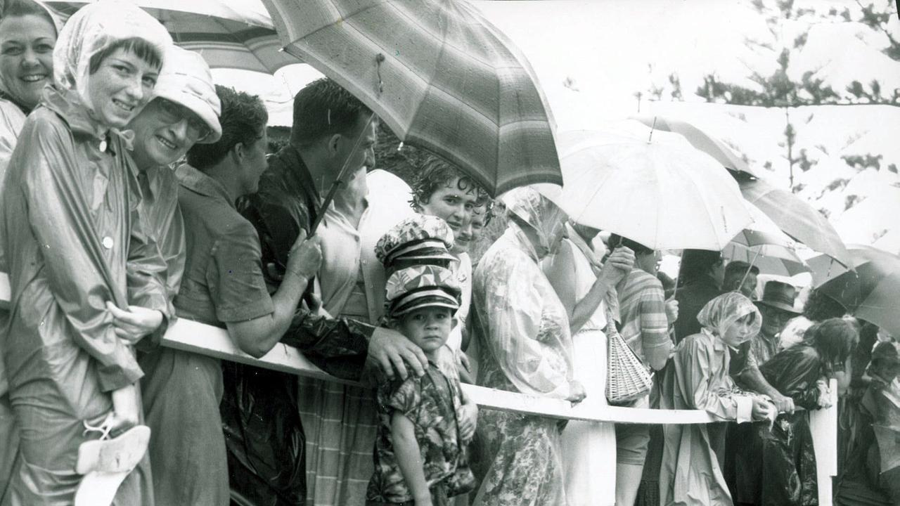 Gold Coast Crowds wait for Queen Elizabeth II in rain at Coolangatta Surf carnival 1963.