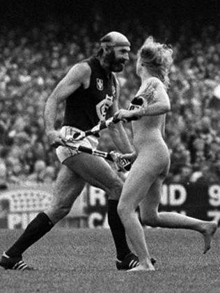 Carlton’s Bruce Doull holding onto streaker Helen D’Amico’s scarf after she ran on the field, stopping play for several minutes. Picture: HWT Library.