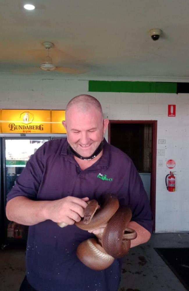 Goldfields Hotel Motel general manager Jason Grove with the pub's pet snake. Picture: Facebook