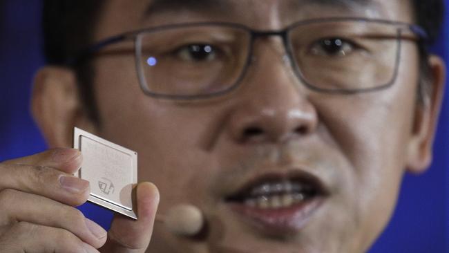 Ryan Ding, chief of Huawei's carrier business group, holds a Tiangang 5G base station chipset, speaks during a product presentation in Beijing, Thursday, Jan. 24, 2019. Chinese tech giant Huawei announced plans to release a next-generation smartphone based on its own technology instead of U.S. components, stepping up efforts to compete with global industry leaders. (AP Photo/Andy Wong)