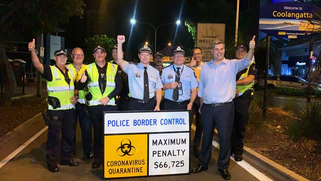 Queensland Police Superintendent Mark Wheeler and staff celebrate the reopening of the border at the Griffith Street checkpoint. Photo: Scott Powick.