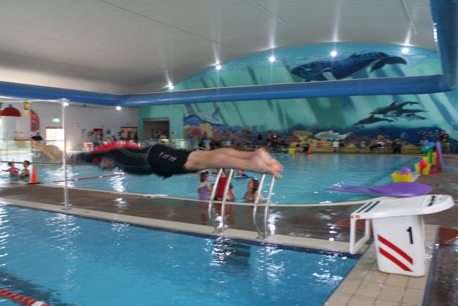 Lismore City Council general manager Gary Murphy dives into the GSAC pool after swimming lessons recommenced this week.