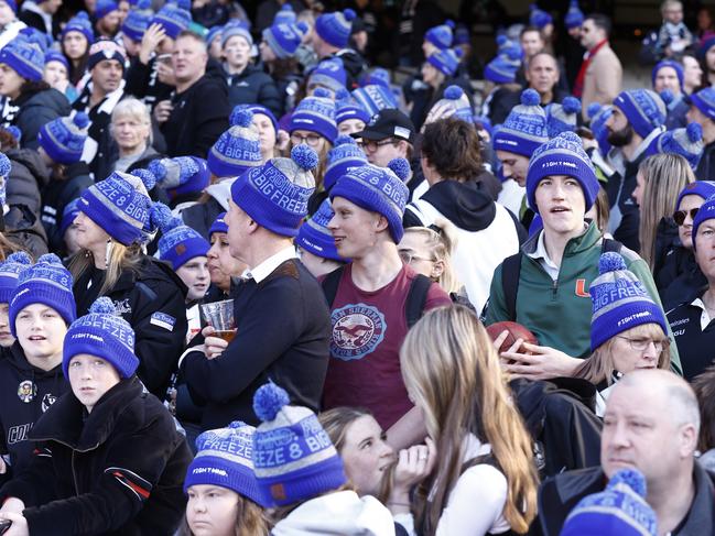 MELBOURNE, AUSTRALIA - JUNE 13: Fans are seen wearing Fight MND beanies during the Big FightMND Freeze 8 during the round 13 AFL match between the Collingwood Magpies and the Melbourne Demons at Melbourne Cricket Ground on June 13, 2022 in Melbourne, Australia. (Photo by Darrian Traynor/Getty Images)