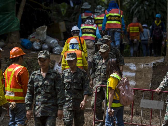 Thai soldiers and volunteers are seen at the entrance of Tham Luang cave.