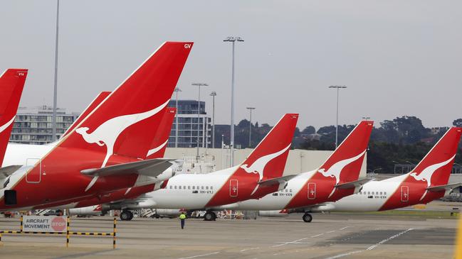 The tails of Qantas planes are lined up at Sydney Airport in Sydney, Sunday, Oct. 30, 2011. Qantas Airways grounded all of its aircraft around the world indefinitely Saturday due to ongoing strikes by its workers. (AP Photo/Rick Rycroft)