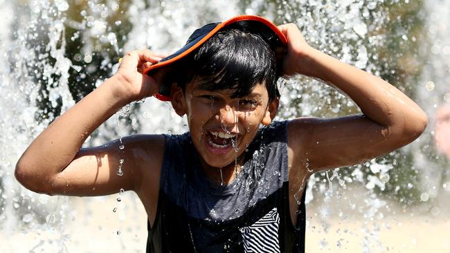 A young fan cools off a fountain at the Australian Open on Friday. Picture: Matt King/Getty Images