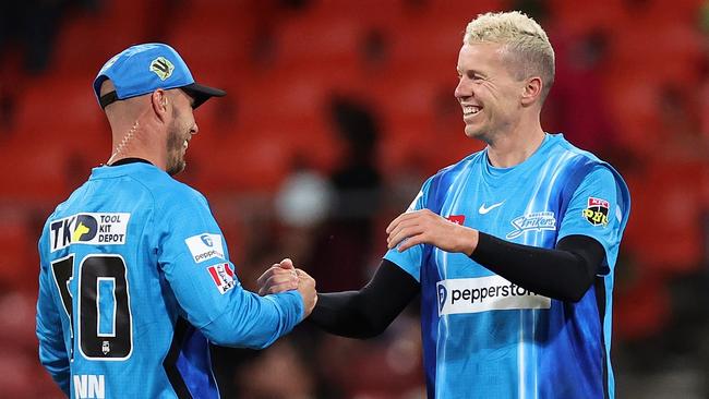 Chris Lynn and Peter Siddle celebrate their history-making victory. Picture: Cameron Spencer/Getty Images