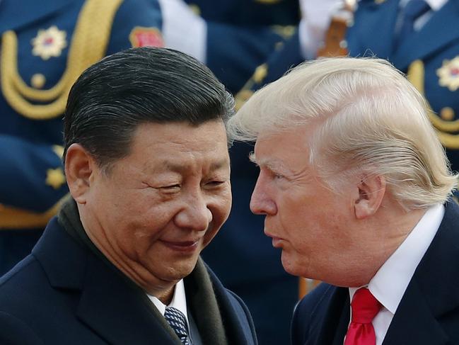 FILE - In this Nov. 9, 2017, file photo, U.S. President Donald Trump, right, chats with Chinese President Xi Jinping during a welcome ceremony at the Great Hall of the People in Beijing. China said Friday, Oct. 12, 2018 it is in contact with the United States amid reports of a planned meeting between President Xi Jinping and President Donald Trump next month following a dive in the U.S. stock market blamed partly on a growing trade war between the world's two largest economies. (AP Photo/Andy Wong, File)