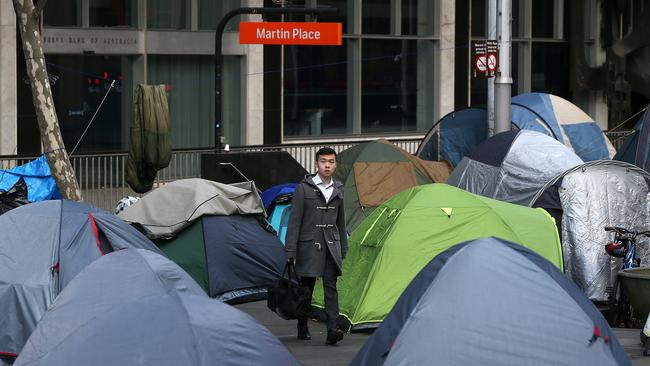 A worker navigates his way through Martin Place tent city. Picture: Toby Zerna