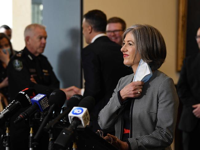 Chief Public Health Officer Professor Nicola Spurrier at a press conference in Old Parliament House. The Premier shakes Mr Stevens’ hand in the background. Picture: NCA NewsWire / Naomi Jellicoe