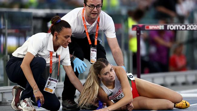 Officials rushed to her aid. Photo by Anne-Christine POUJOULAT / AFP