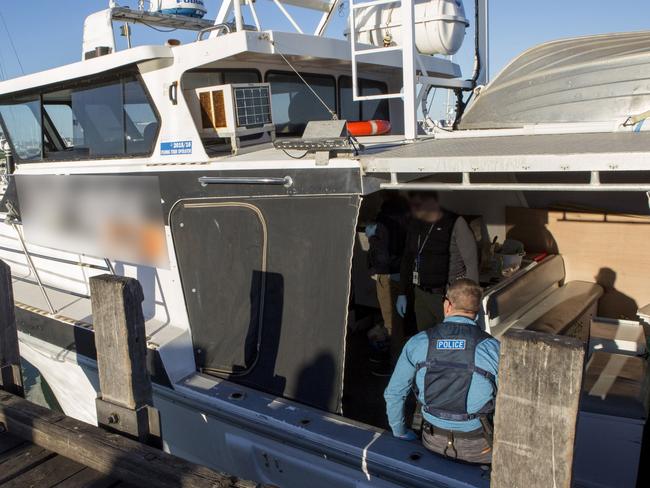 Police search a vessel as part of the record 1.2 tonne bust of methamphetamine.