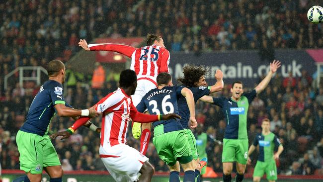 Stoke City's Peter Crouch, centre in air, scores.