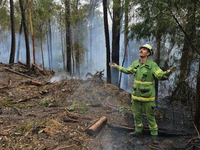 Forest Fire Management Victoria's Brodie Leticq welcomes the rain at Briagolong.