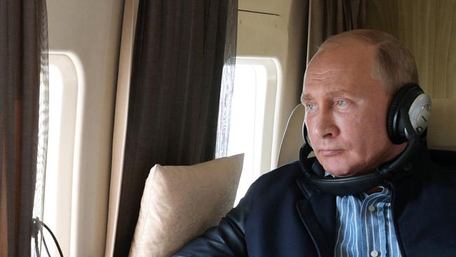 Russian President Vladimir Putin sits aboard a helicopter. Picture: AFP