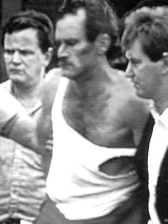 Russell ‘Mad Dog’ Cox sporting his ripped T-shirt on arrest at Doncaster Shopping Centre in 1988.