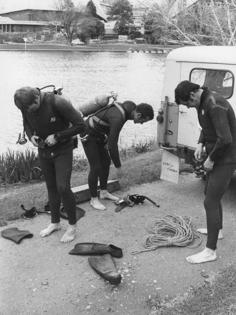 Police divers prepare to search the Torrens for the two girls.