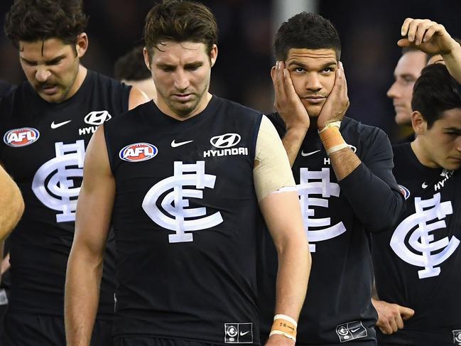 MELBOURNE, AUSTRALIA - JUNE 16:  The Blues look dejected after losing the round 13 AFL match between the Carlton Blues and the Fremantle Dockers at Etihad Stadium on June 16, 2018 in Melbourne, Australia.  (Photo by Quinn Rooney/Getty Images)