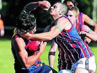 The Noosa Tigers’ Todd Panoho is collared by a Wilston Grange defender at Weyba Road last month. Picture: Geoff Potter