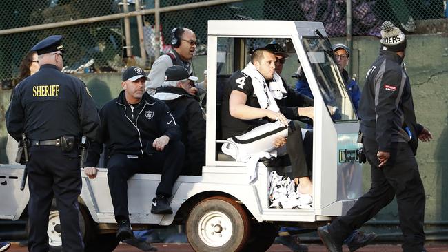 Oakland Raiders quarterback Derek Carr (4) is taken off the field in a cart.