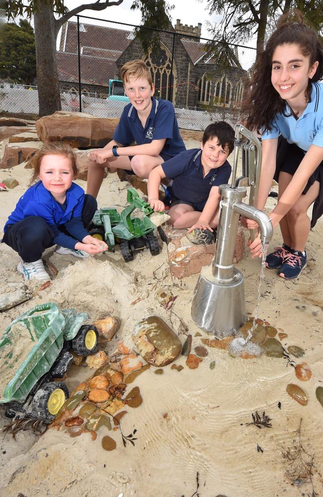 Kew Primary School students Sam (year 6), Ted (year 1), Sophie (year 6) and Maddie (year 1) enjoy their revamped playground. Picture: Tony Gough