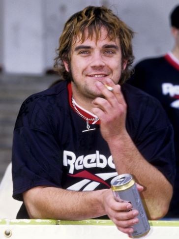 Robbie Williams, pictured in 1996, says his past world was full of insecurity. Picture: Getty Images