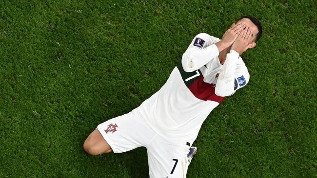 Portugal's forward #07 Cristiano Ronaldo reacts during the Qatar 2022 World Cup quarter-final football match between Morocco and Portugal at the Al-Thumama Stadium in Doha on December 10, 2022. (Photo by MANAN VATSYAYANA / AFP)