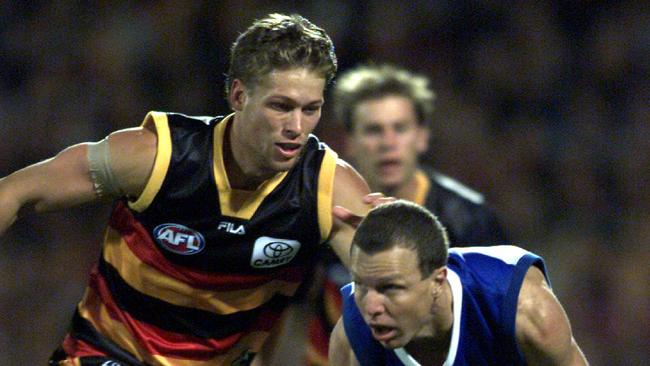 Evan Hewitt chases North Melbourne’s John Blakey at Football Park in 2001.